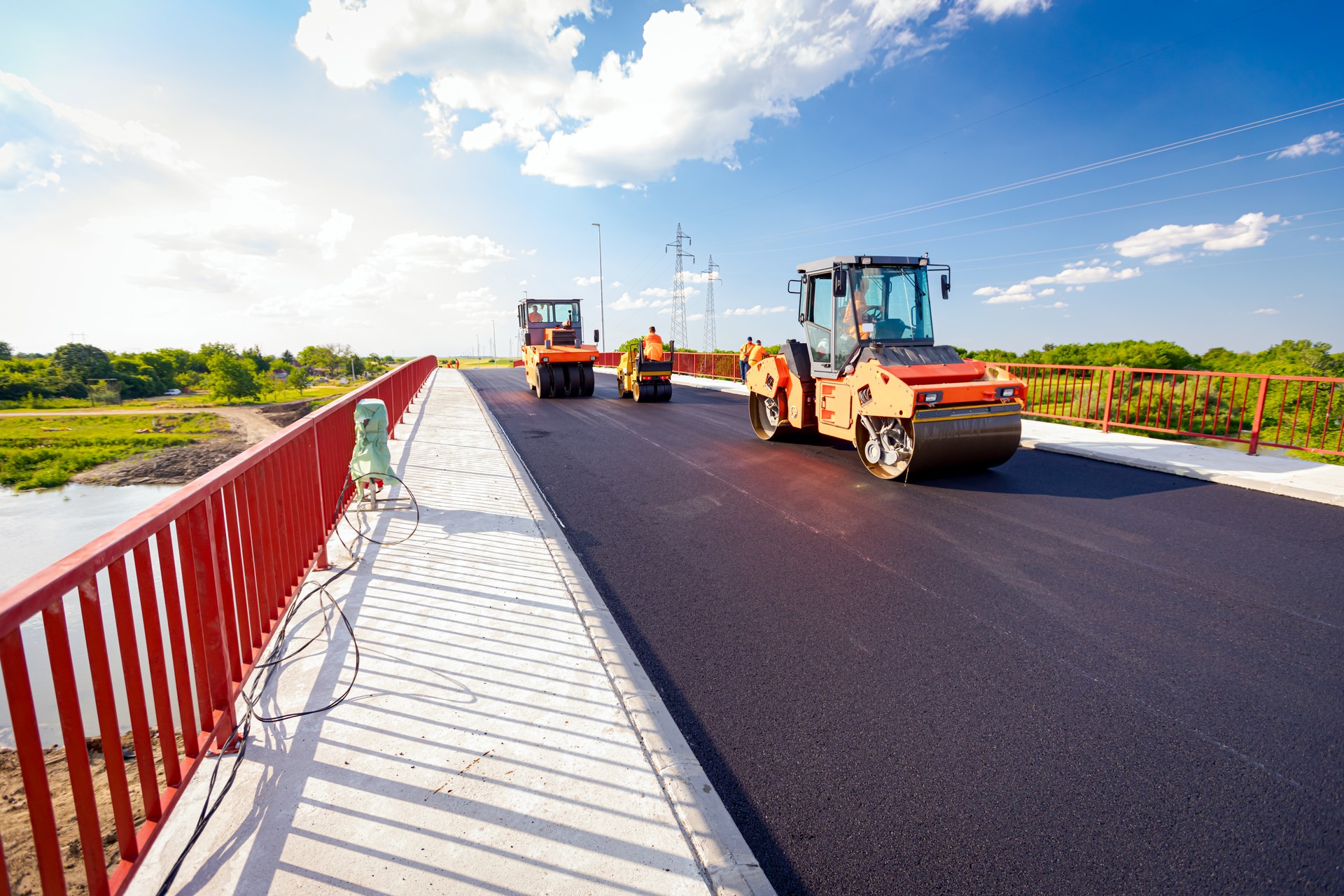 Hot asphalt is spreading with steamroller during road works