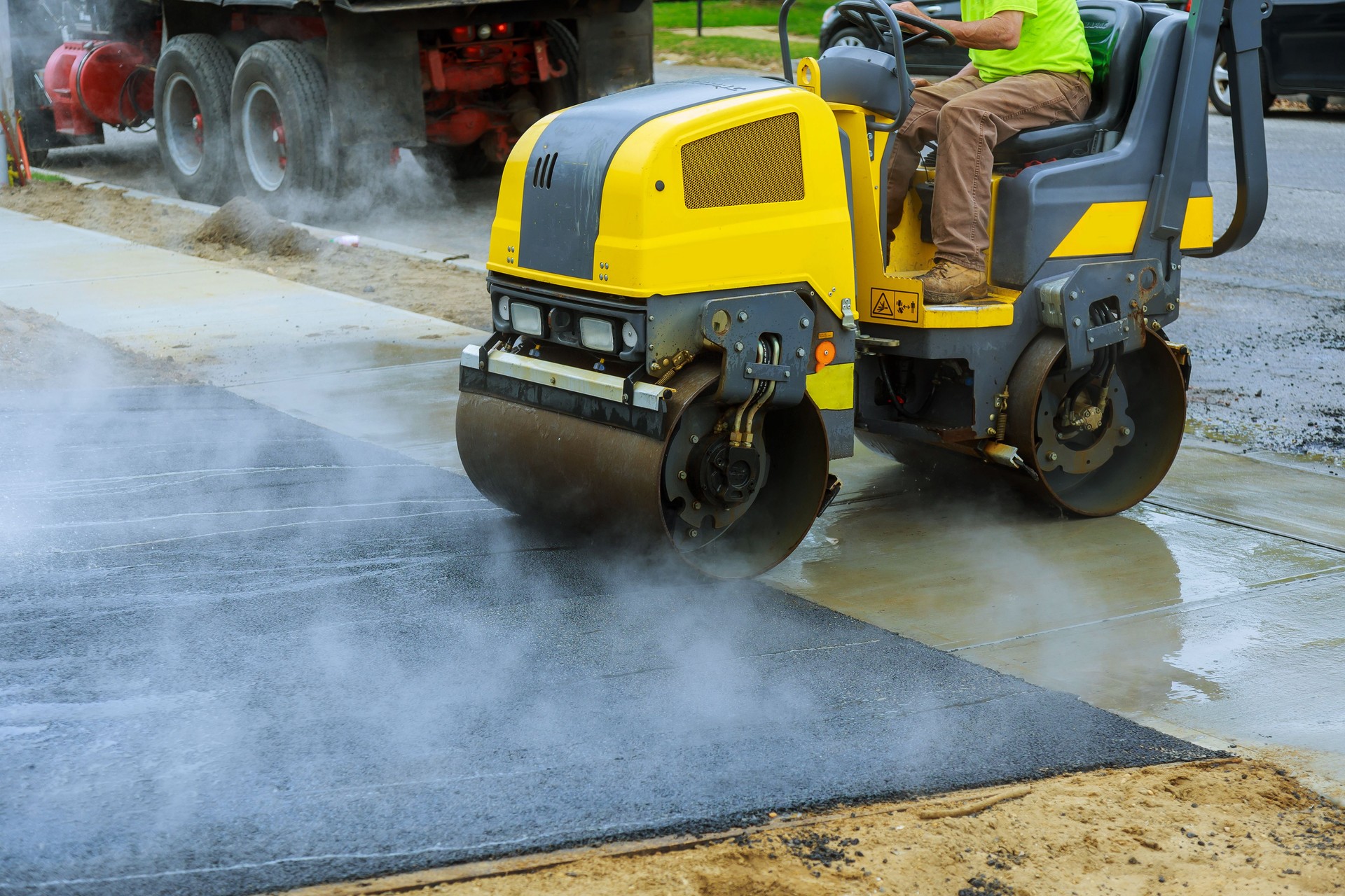 Asphalting construction works with commercial repair equipment road crews