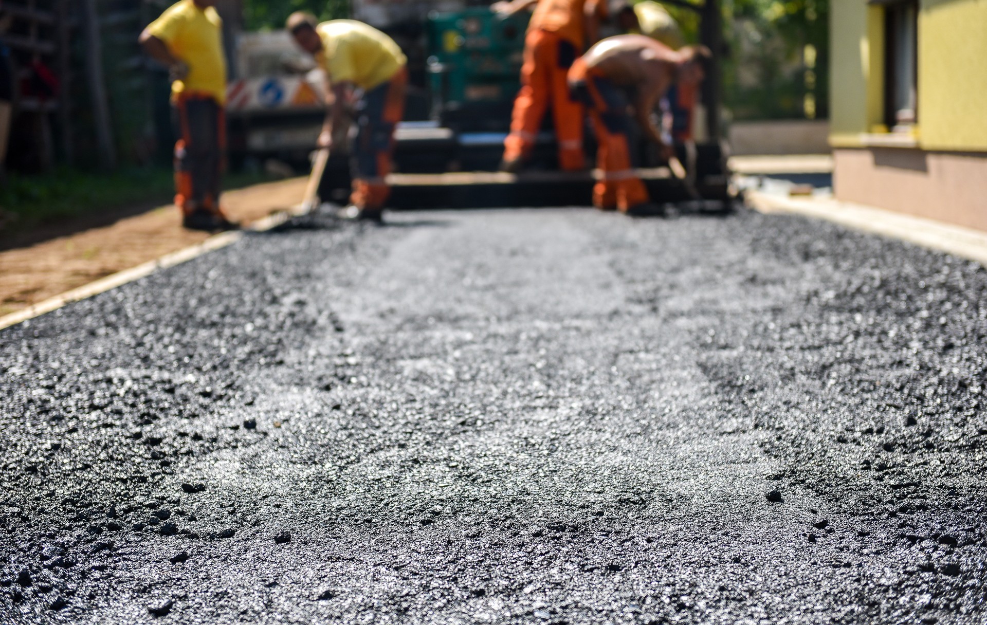 Team of Workers making and constructing asphalt road constructio