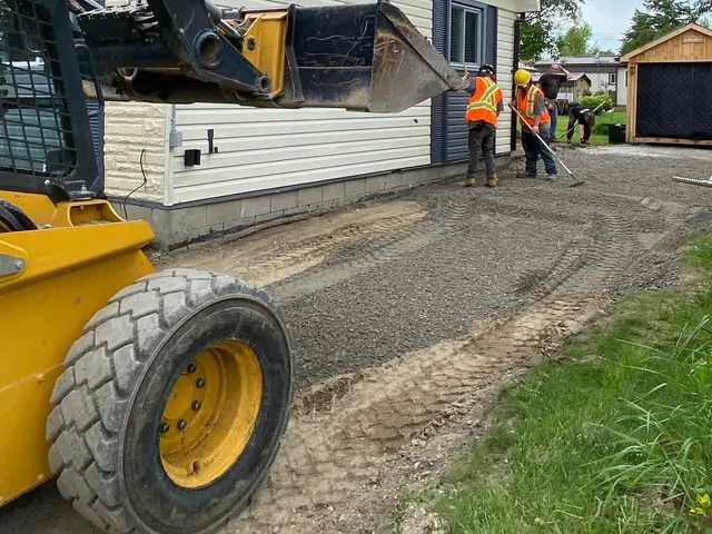 Harwick Paving crew levelling the gravel base of a driveway before asphalt is laid